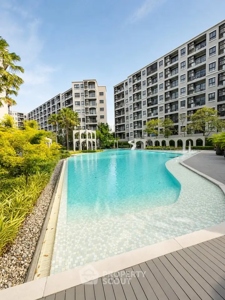 Luxurious apartment complex with stunning pool and lush landscaping
