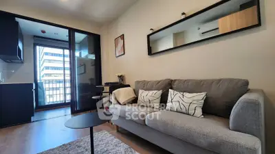 Modern living room with stylish sofa and balcony view in urban apartment
