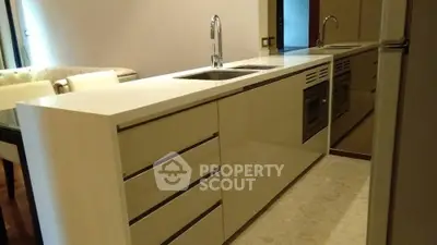 Modern kitchen with sleek cabinetry and integrated appliances in open layout