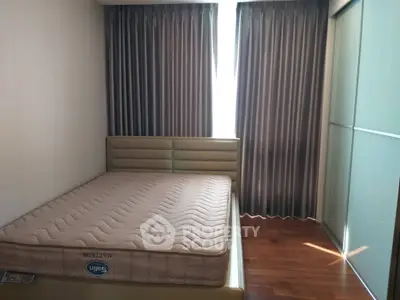 Cozy bedroom with elegant curtains and hardwood flooring