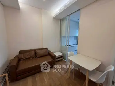 Cozy living room with modern sofa and dining area in compact apartment