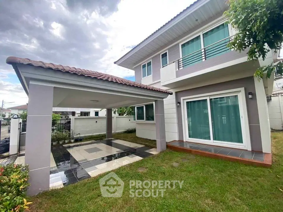 Modern two-story house with spacious carport and lush green lawn