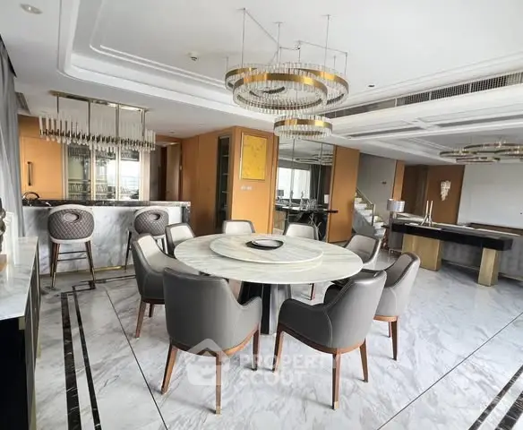 Luxurious dining area with elegant marble flooring and modern chandelier in upscale apartment.
