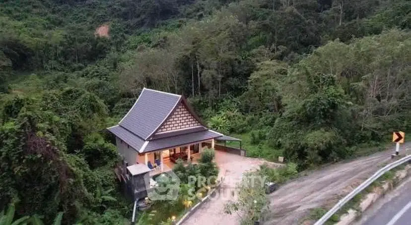 Charming hillside cottage surrounded by lush greenery and scenic views