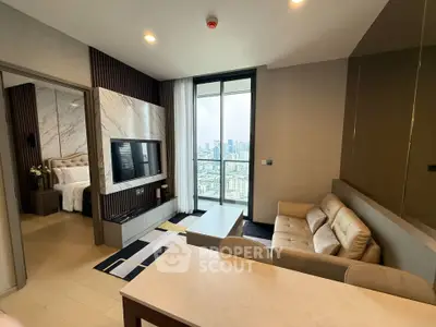 Luxurious modern living room with city view, elegant decor, and open layout connecting to a stylish bedroom.