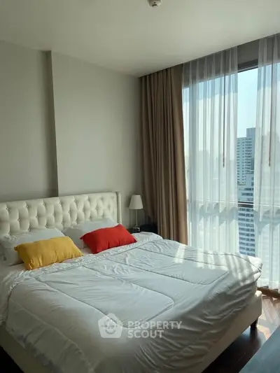 Modern bedroom with city view and stylish decor