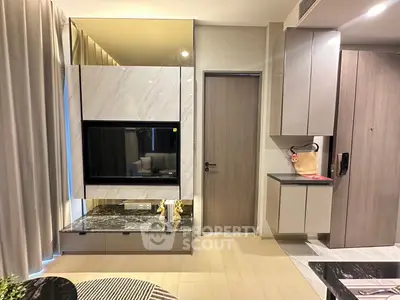 Modern living room with sleek cabinetry and stylish decor in a contemporary apartment.