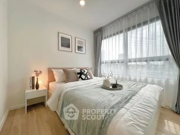 Bright and cozy bedroom with large window and elegant decor