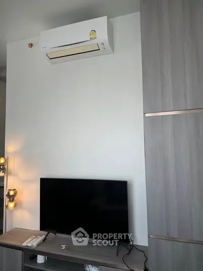 Modern living room with air conditioner and TV setup