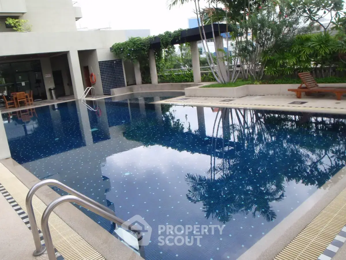 Luxurious residential pool area with lush greenery and modern design
