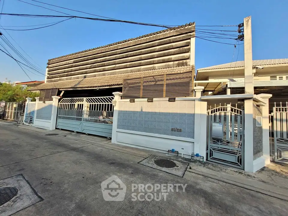 Charming residential property with gated entrance and unique architectural design.
