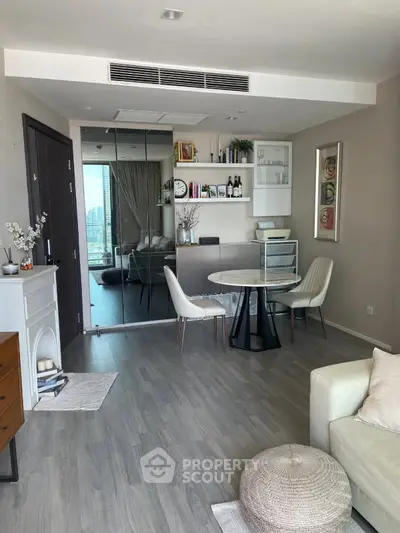 Modern living room with stylish decor and city view, featuring elegant dining area and cozy seating.