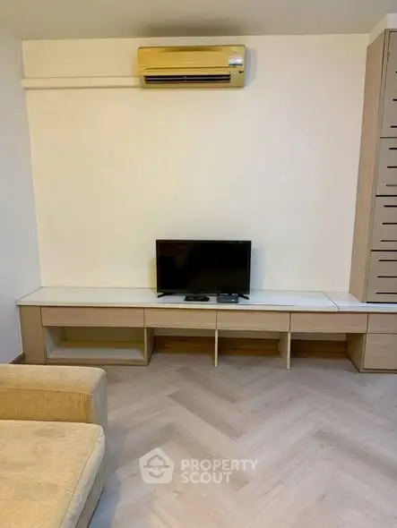 Modern living room with air conditioning and sleek TV setup