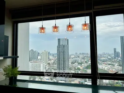 Stunning cityscape view from modern kitchen with stylish pendant lights.