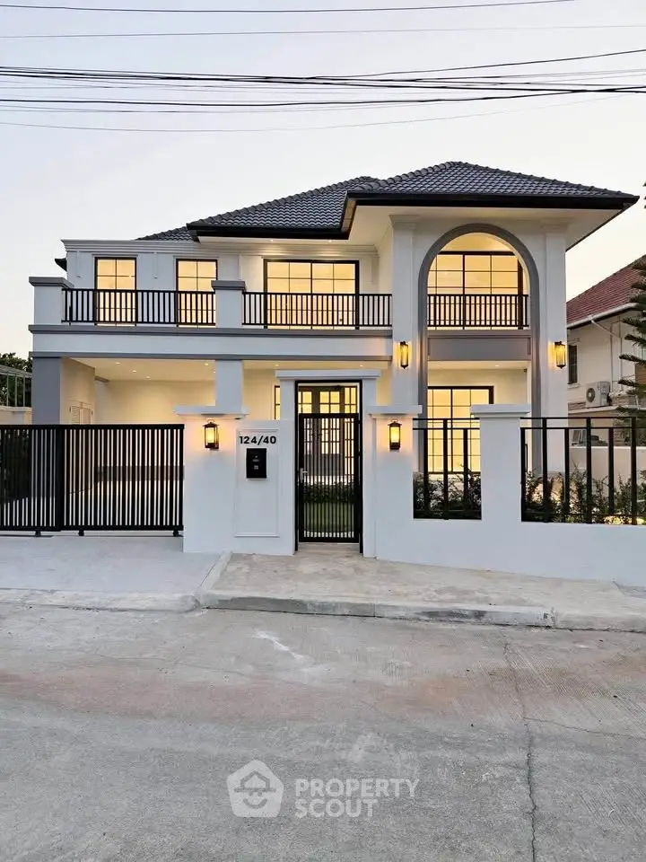 Stunning modern two-story house with elegant facade and spacious balcony, perfect for luxurious living.