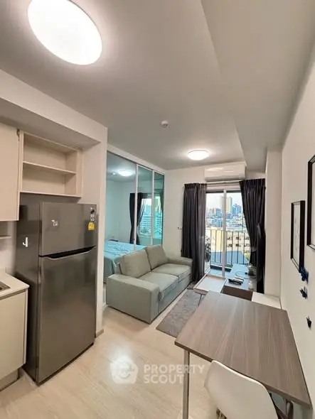 Modern studio apartment with open layout and city view balcony.