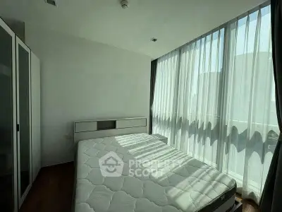 Bright and airy bedroom with large windows and modern furnishings