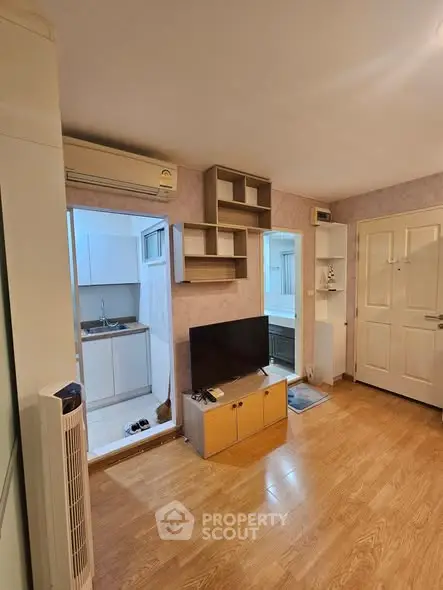 Cozy living room with wooden flooring and modern TV setup