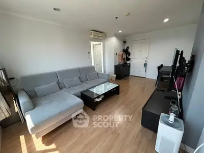 Spacious living room with modern furniture and wooden flooring