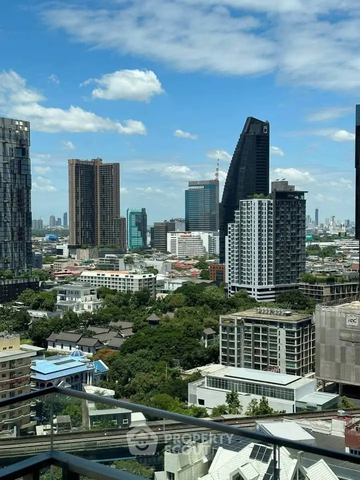 Stunning cityscape view from a high-rise balcony showcasing modern skyscrapers and lush greenery.