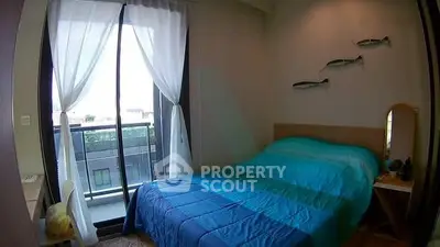 Cozy bedroom with balcony access and stylish decor