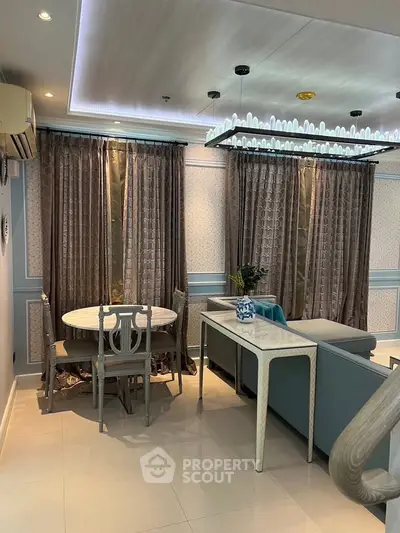 Elegant living room with stylish furniture and chic decor, featuring a cozy dining area and luxurious curtains.