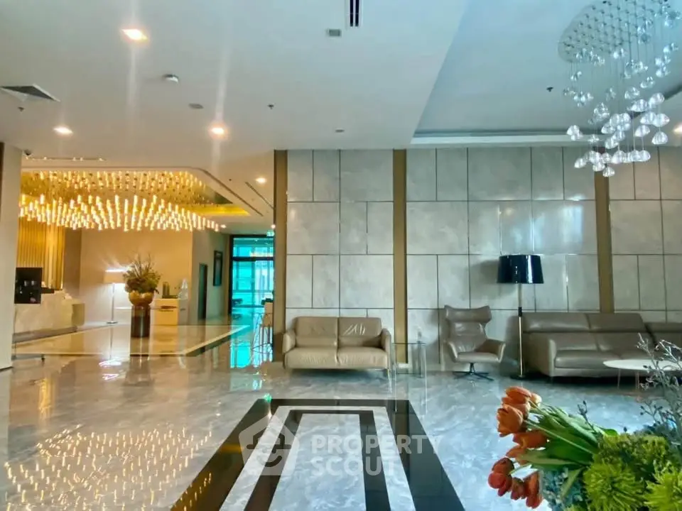 Luxurious modern lobby with elegant lighting and stylish seating in a high-end building.