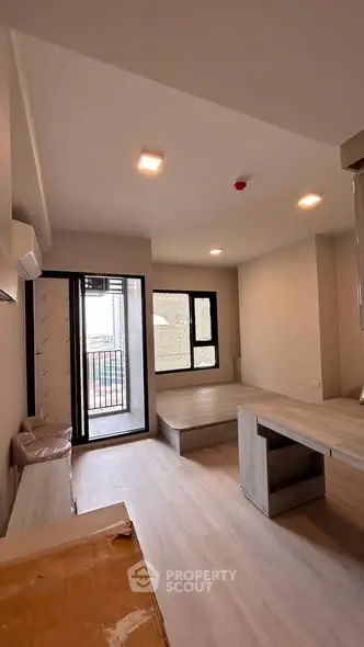 Modern living room with open layout and balcony access in a stylish apartment.