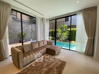 Luxurious living room with pool view and elegant sofa in modern home