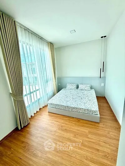 Bright and airy bedroom with large window and modern decor