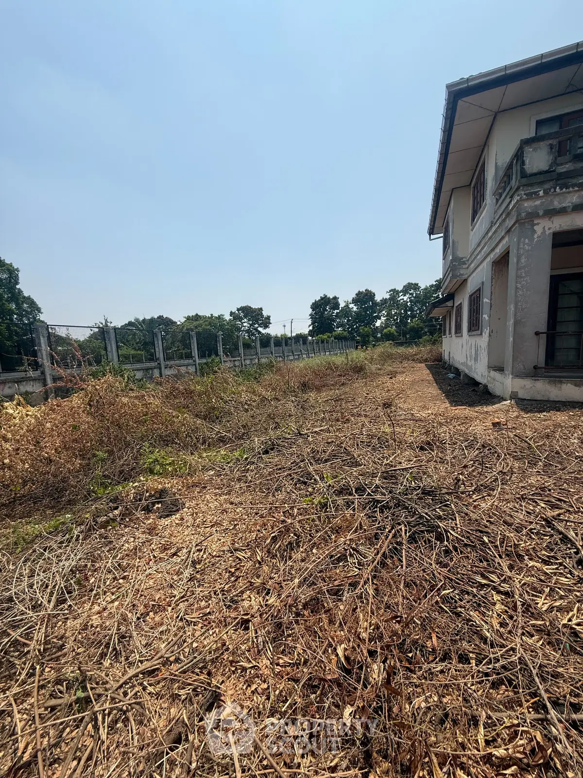 Spacious plot with partially constructed building, ideal for development opportunities.