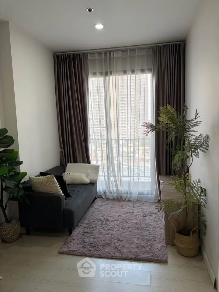 Cozy living room with large window and city view, featuring a plush rug and modern decor.