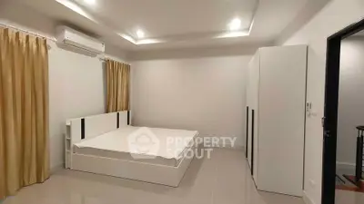 Spacious modern bedroom with sleek design and ample natural light