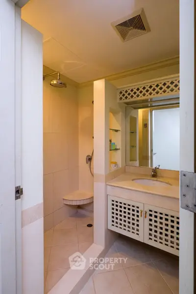 Modern bathroom with spacious shower and elegant vanity in a stylish home.