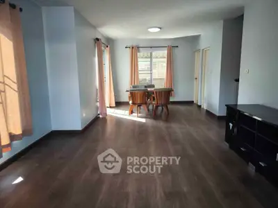 Spacious living room with elegant dining area and large windows for natural light.