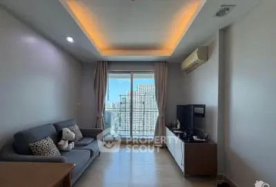 Modern living room with city view, featuring cozy sofa and entertainment unit, ideal for urban living.