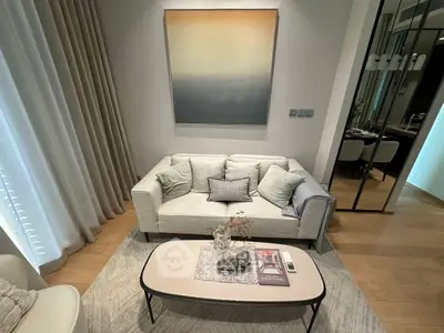 Elegant living room with modern decor, featuring a cozy sofa, stylish coffee table, and contemporary artwork.