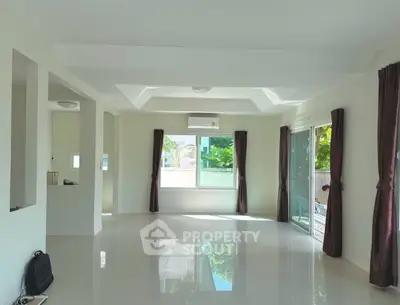 Spacious and bright living room with large windows and modern design.