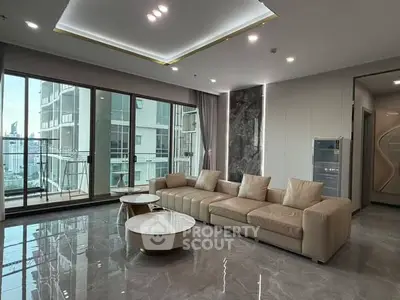 Luxurious modern living room with large windows and elegant furnishings