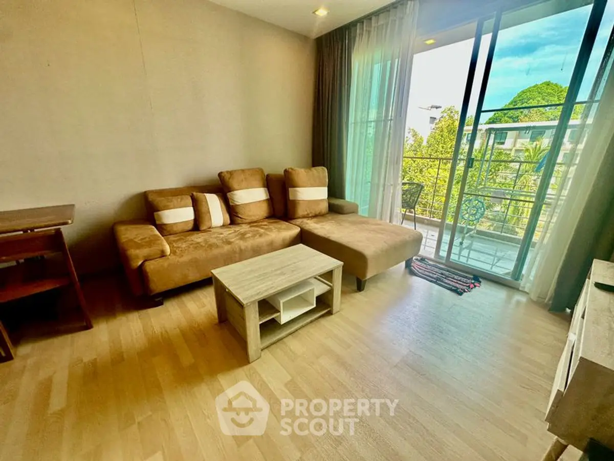 Spacious living room with cozy sofa and balcony view in modern apartment