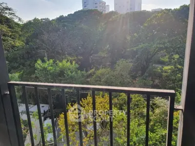 Charming balcony view overlooking lush greenery and cityscape, perfect for nature lovers seeking tranquility.