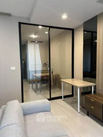 Modern living room with glass partition and cozy furniture