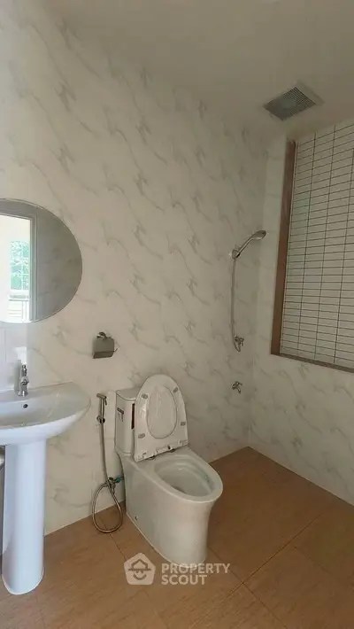 Spacious bathroom with modern fixtures and elegant tile design