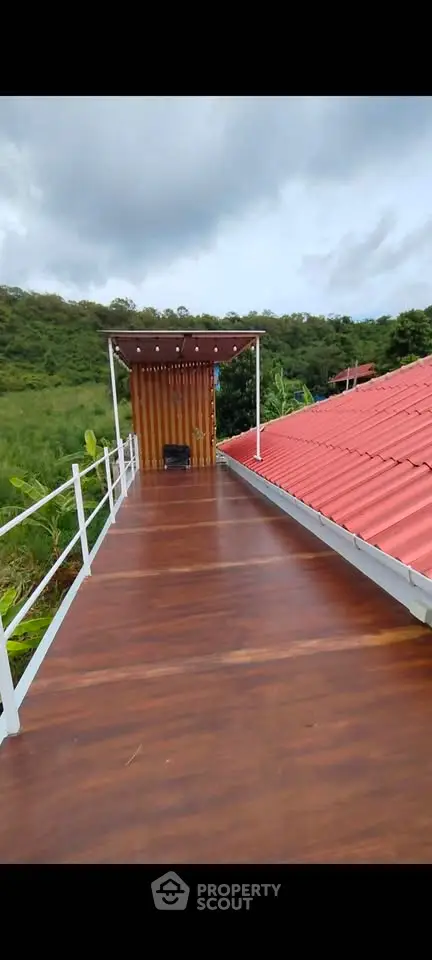Stunning rooftop terrace with wooden deck and scenic views, perfect for relaxation and outdoor gatherings.