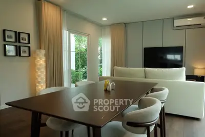 Elegant modern living room with dining area and stylish furniture