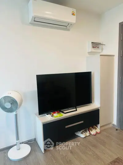Modern living room with sleek TV stand and air conditioning unit