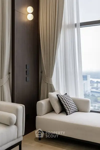 Luxurious modern living room with elegant white sofas and panoramic city view.