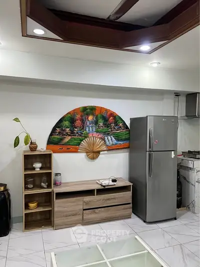 Modern kitchen with sleek fridge and stylish decor, perfect for contemporary living.