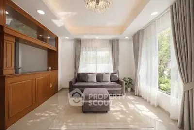 Elegant living room with large windows, plush sofa, and modern chandelier in a bright, airy space.