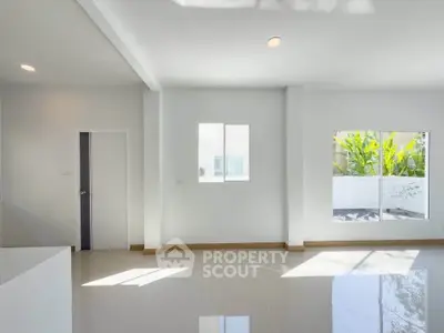 Bright and spacious living room with large windows and modern design